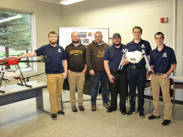 ICC students with Alan and Matt posing with drones.